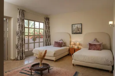 a bedroom with two beds and a window at Villa Monica in Marrakech