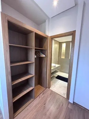 a walk in closet with wooden shelves and a mirror at Villa 4 Suites with Pool, near Hivernage in Marrakech