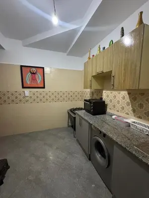 a kitchen with a washing machine in a room at appartement lumineux familial, vue sur l'océan avec wifi rapide in Marrakech