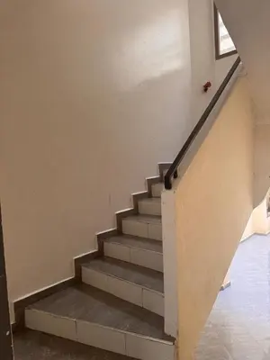 a staircase in a house with a stair case at appartement lumineux familial, vue sur l'océan avec wifi rapide in Marrakech