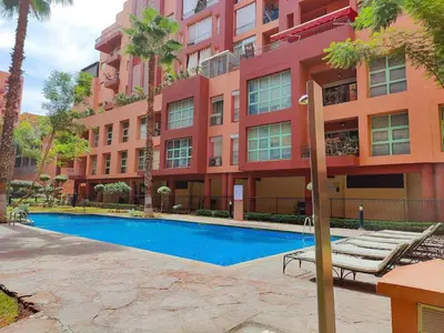 a hotel with a swimming pool in front of a building at Gueliz 3BR 3BA Duplex Pool & Balcony Majorelle in Marrakech