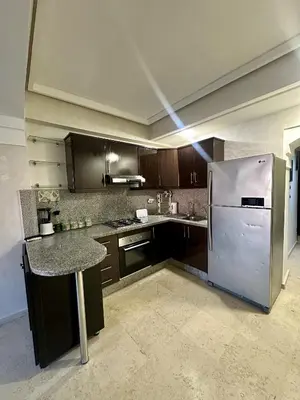 a kitchen with a stainless steel refrigerator and a counter at studio équipé et centrale -Guéliz in Marrakech