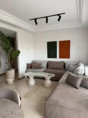 a living room with a couch and a table at Beautiful apartment in Premium Village Marrakech in Marrakech
