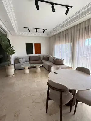 a living room with a couch and a table at Beautiful apartment in Premium Village Marrakech in Marrakech