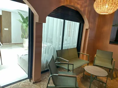 a room with two chairs and a table and a window at Beautiful apartment in Premium Village Marrakech in Marrakech