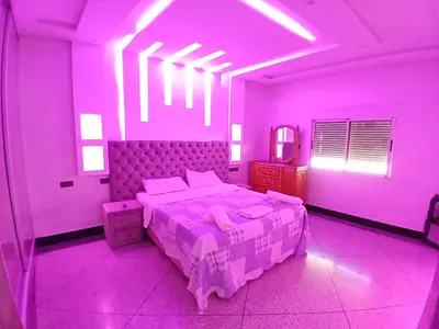 a purple bedroom with a bed and a mirror at AU GC Gueliz Cosy in Marrakech