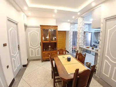 a kitchen and dining room with a table and chairs at AU GC Gueliz Cosy in Marrakech