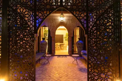an entrance to a house with an open door with chairs at Riad azzouina in Marrakech