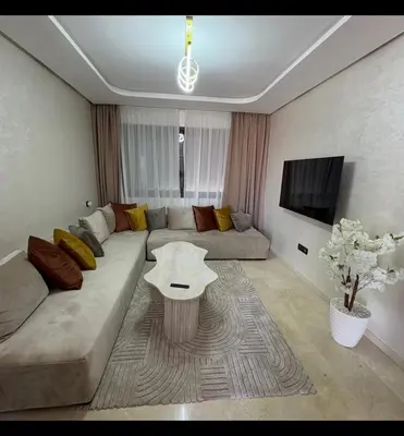 a living room with a couch and a table at Residence hôte standing Marrakech Gueliz in Marrakech