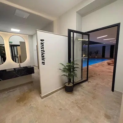 a room with a potted plant next to a wall with mirrors at Residence hôte standing Marrakech Gueliz in Marrakech