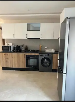 a kitchen with white cabinets and a dishwasher at Residence hôte standing Marrakech Gueliz in Marrakech