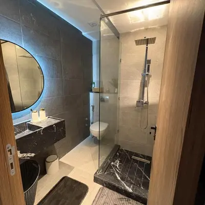 a bathroom with a shower and a toilet and a sink at Residence hôte standing Marrakech Gueliz in Marrakech