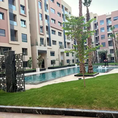 a courtyard with a swimming pool in a building at Residence hôte standing Marrakech Gueliz in Marrakech