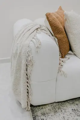 a white couch with a blanket on top of it at Premium Hospitality - Hivernage Marrakech in Marrakech