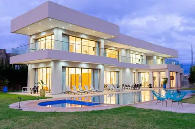 a large house with a swimming pool in front of it at Golfside Villas in Marrakech