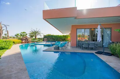 a swimming pool in the backyard of a house at Golfside Villas in Marrakech