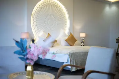 a bedroom with a bed with a large mirror at Golfside Villas in Marrakech