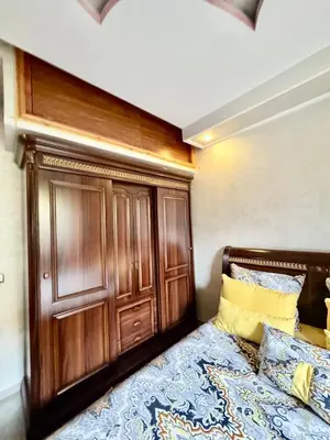 a bed with a wooden headboard in a bedroom at Beldi Luxury apartment near M Avenue with Free Parking in Marrakech
