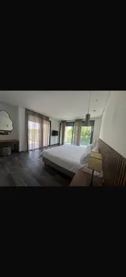 a bedroom with a bed and some windows at Villa Alya in Marrakech