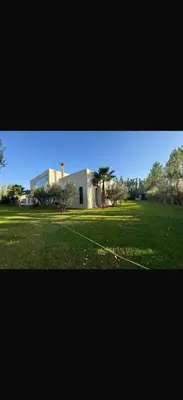 a large field with a building in the background at Villa Alya in Marrakech