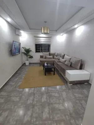 a living room with a couch and a table at Appartement de luxe in Marrakech