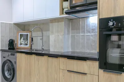 a kitchen with a sink and a washing machine at Nova Collection - Hivernage Marrakech in Marrakech
