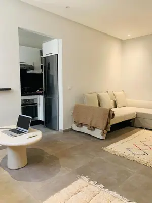 a living room with a couch and a laptop on a table at 1 bedroom apartment Miramas 2, gueliz in Marrakech