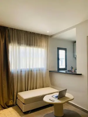 a room with a couch and a laptop on a table at 1 bedroom apartment Miramas 2, gueliz in Marrakech