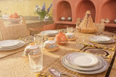 a table with plates and dishes on top of it at Riad Safran - Private Cook & Indoor Pool Gem in Marrakech