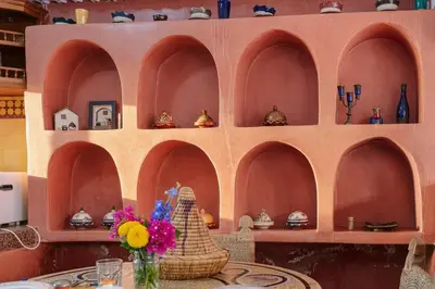 a room with a table with a vase of flowers at Riad Safran - Private Cook & Indoor Pool Gem in Marrakech