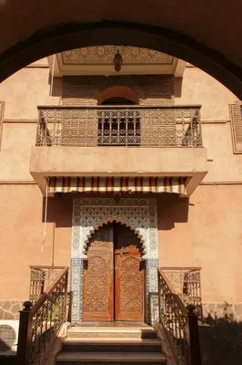 an entrance to a building with a large wooden door at Riad Safran - Private Cook & Indoor Pool Gem in Marrakech