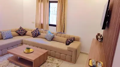 a living room with a couch and a table at Appartement Aéroport Suite Marrakech-M9 in Marrakech