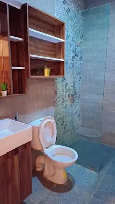 a bathroom with a toilet and a sink and a shower at Appartement Aéroport Stay Marrakech-M9 in Marrakech