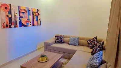 a living room with a couch and a table at Appartement Aéroport Stay Marrakech-M9 in Marrakech