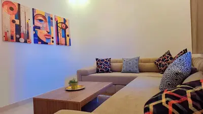 a living room with a couch and a table at Appartement Aéroport Sunset Marrakech in Marrakech