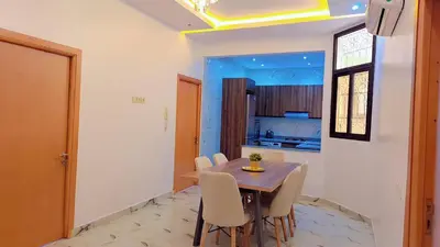 a kitchen and dining room with a table and chairs at Appartement Aéroport Sunset Marrakech in Marrakech