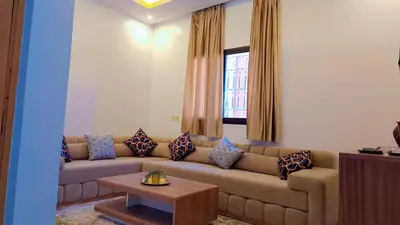 a living room with a couch and a table at Appartement Aéroport Center Marrakech in Marrakech