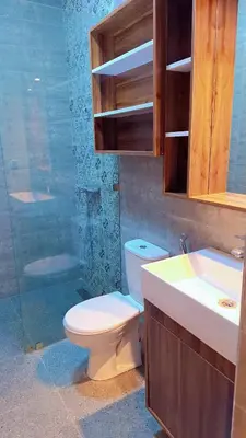 a bathroom with a toilet and a sink and a shower at Appartement Aéroport Center Marrakech in Marrakech