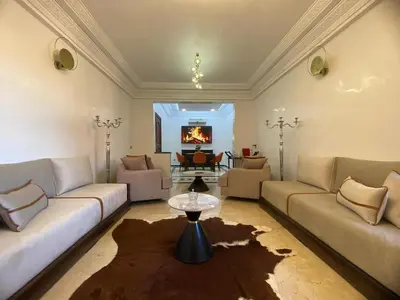 a living room with two couches and a table at Elegance and comfort in the heart of Marrakech in Marrakech