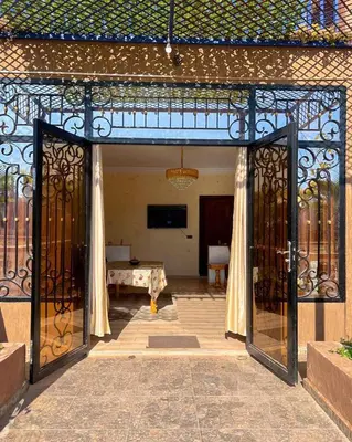 an entrance to a building with an open gate at Charming Family Villa with Private Pool & Garden - Near Marrakech in Sraïri