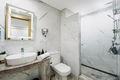 a bathroom with a toilet and a sink and a shower at Terrace & Fast Wi-Fi - Stylish city center flat - Gueliz in Marrakech