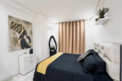 a bedroom with a bed and a mirror at Terrace & Fast Wi-Fi - Stylish city center flat - Gueliz in Marrakech