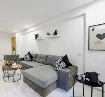 a living room with a couch and a table at Terrace & Fast Wi-Fi - Stylish city center flat - Gueliz in Marrakech