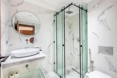 a bathroom with a glass shower and a sink at Modern apartment close to M Avenue & Menara Mall in Marrakech