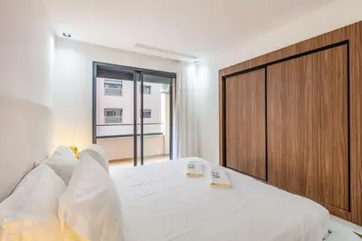 a bedroom with a large bed and a large wooden door at Modern apartment close to M Avenue & Menara Mall in Marrakech