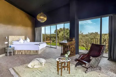 a bedroom with a bed and a desk and a chair at Villa Tacai in Graoua