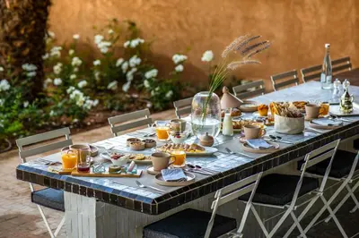 a long table with food and drinks on it at Villa Tacai in Graoua