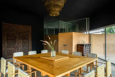 a dining room with a wooden table and chairs at Villa Tacai in Graoua