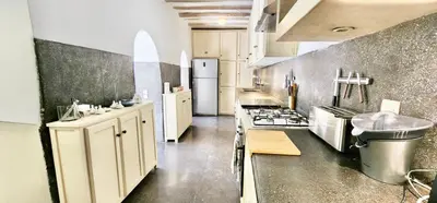 a large kitchen with white cabinets and a stove at Riad Birdy, Charmant et privatif, Piscine, Rooftop, 6 suites, 2 salons, Wifi in Marrakech