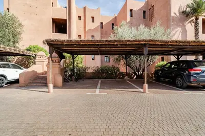 a parking lot in front of a building at appartement avec piscine et charme marocain in Marrakech